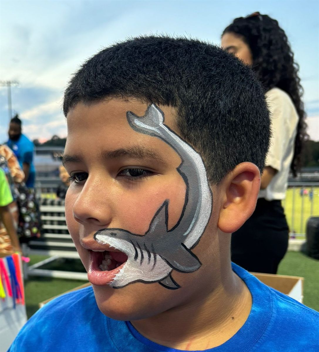 Full-face shark design painted on a child at a Raleigh NC party by Balloon Gram